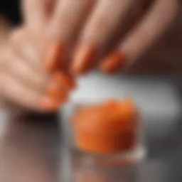 Vibrant orange glitter dip powder in a stylish container
