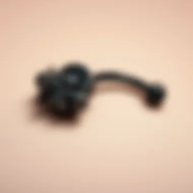 Close-up of a beautifully crafted belly button ring emphasizing its gothic motifs and craftsmanship