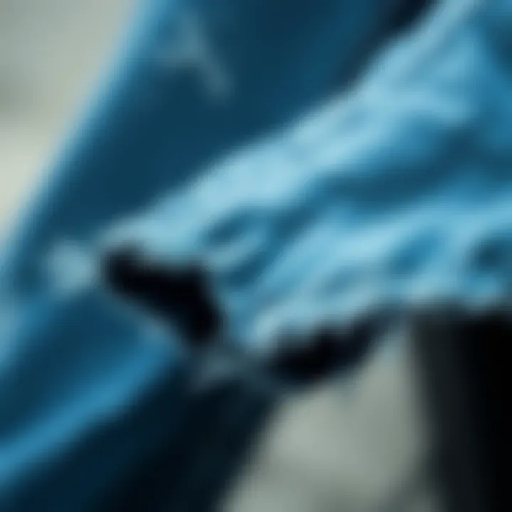 Close-up of the raw hem detailing on flare jeans