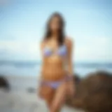 Elegant display of a light purple high waisted bikini on a sandy beach