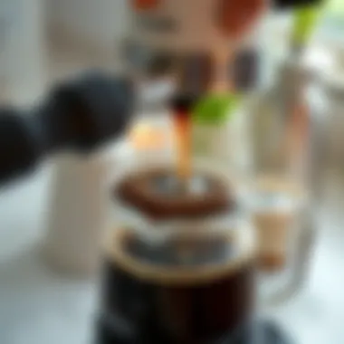 Close-up of coffee brewing in the white stovetop espresso maker
