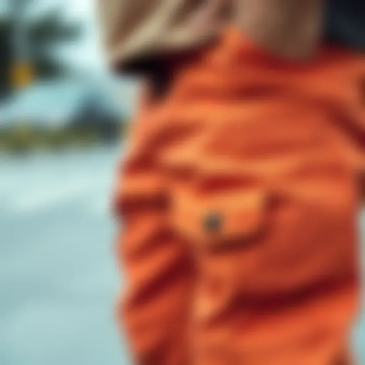 Close-up of orange cargo pants showcasing unique pocket designs and fabric texture