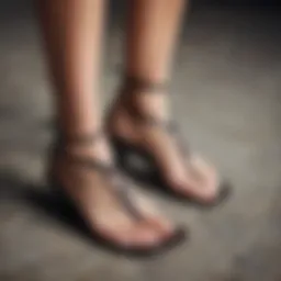 Elegant strappy thong sandals displayed on a textured surface