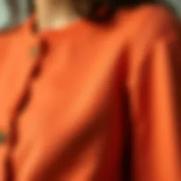 A close-up of an apricot cardigan showcasing its texture and fabric details