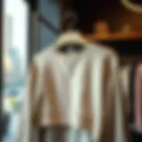 Stylish drop shoulder crop sweatshirt displayed on a hanger
