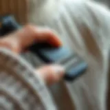 Close-up of a manual fabric shaver in action on a wool sweater